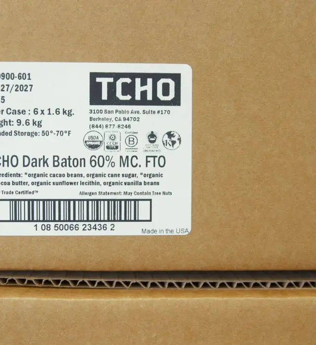 Close-up of a shipping case label for organic dark chocolate batons, showing the USDA Organic seal, ingredient list and barcode.