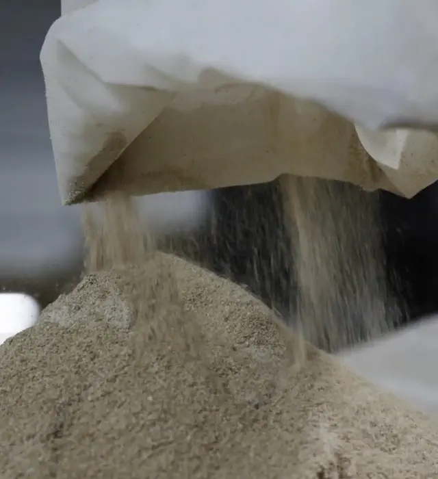 Grain pouring from a sack into a container.