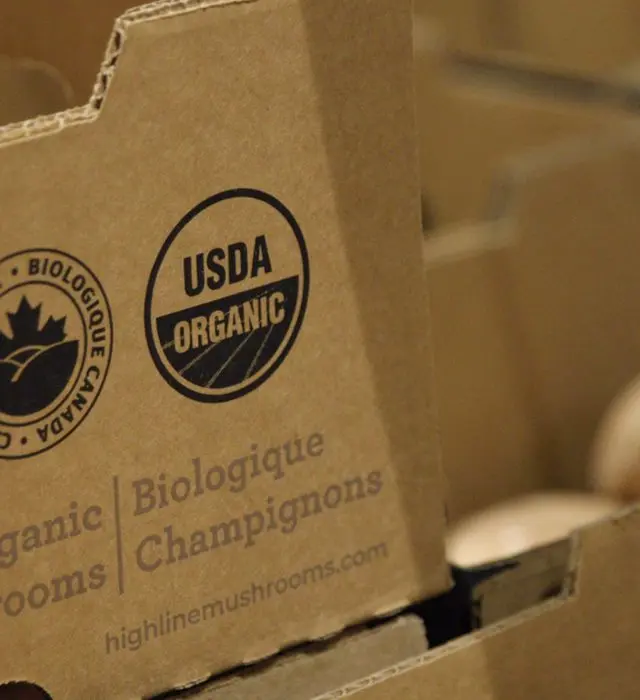 A shipping box for organic mushrooms printed with the USDA Organic seal.