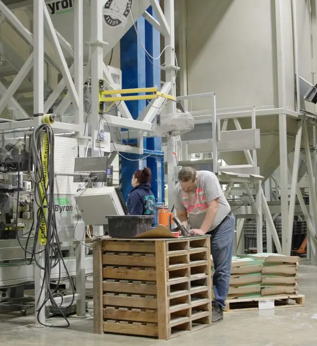 Workers and processing equipment inside a large organic food facility.