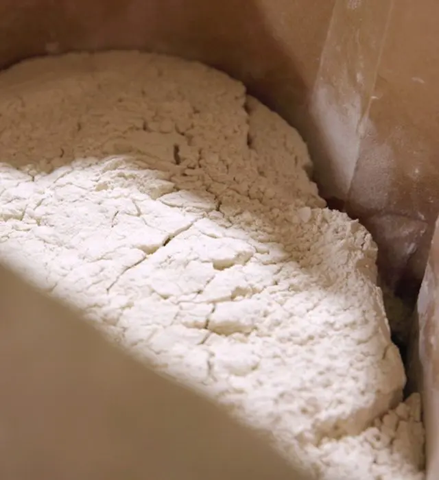 An open sack filled with a powdered ingredient.